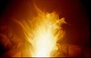 Bright orange and yellow flames burning intensely against a dark background.