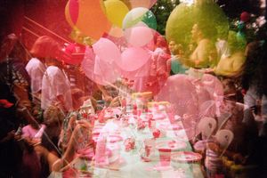 Colorful double exposure photo of children's birthday party with balloons and festive table decorations.