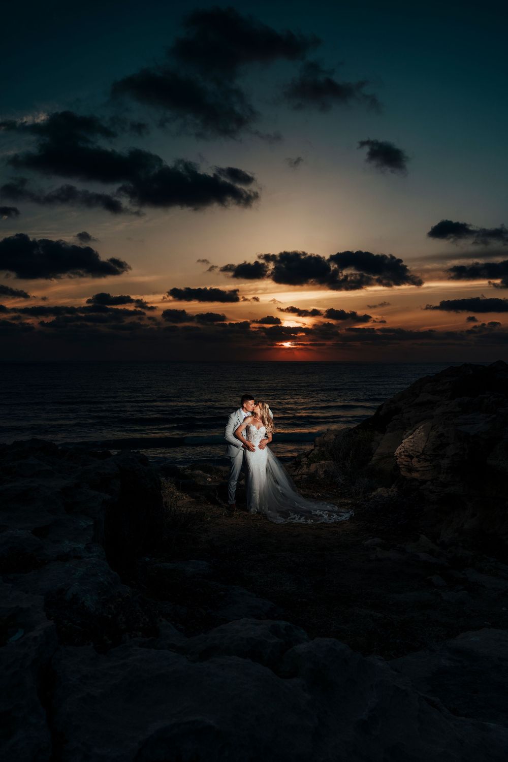 A dramatic series of sunset photos over the ocean with dark clouds and silhouettes on rocky coastline at dusk.