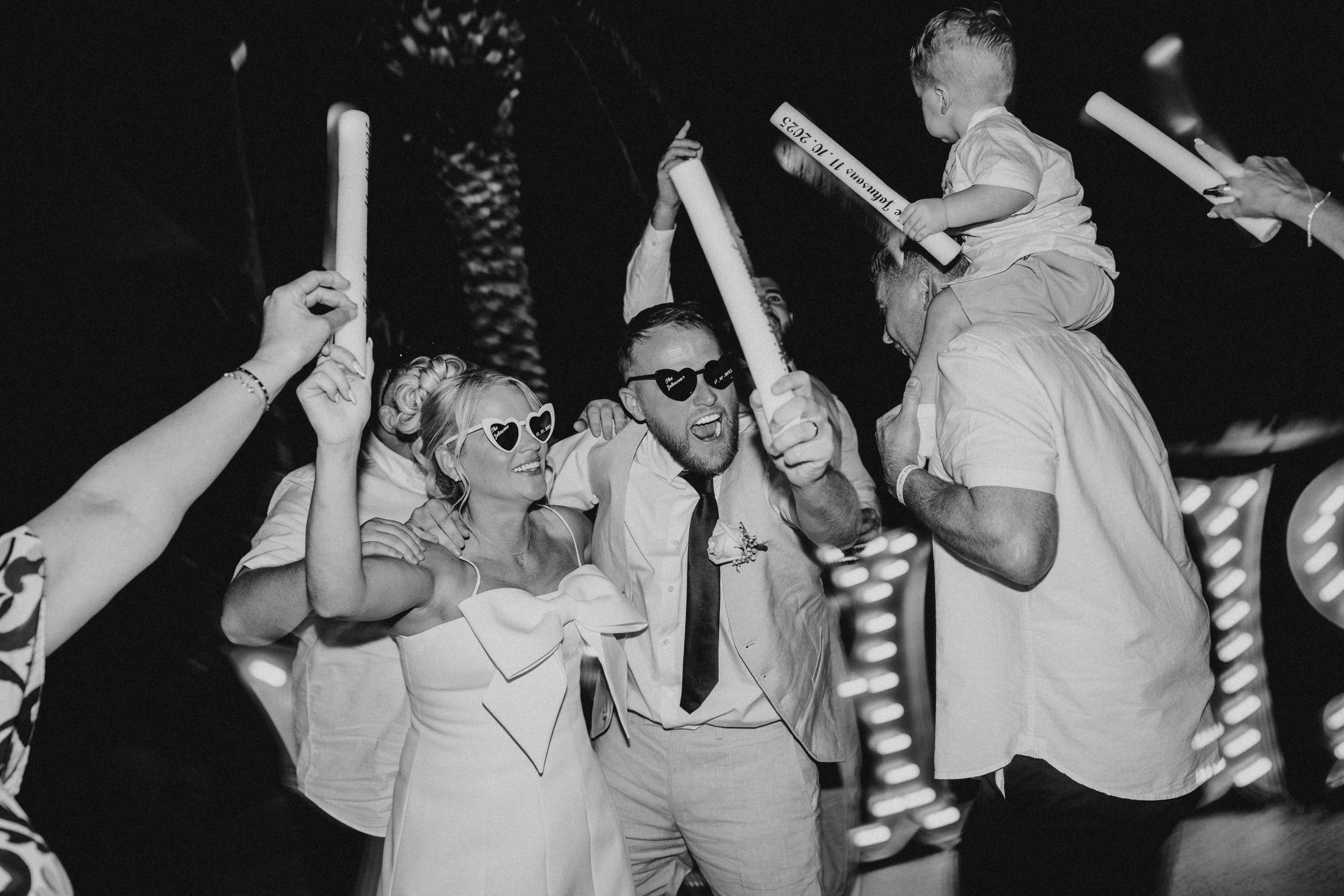 People dancing and celebrating at a party in a black and white photograph.