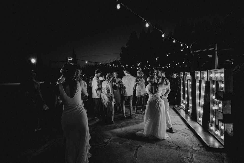 A sequence of wedding party silhouettes dancing and celebrating at a dimly lit evening reception.