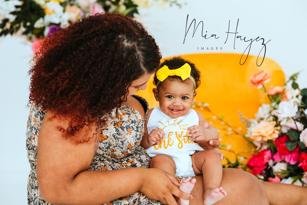 Vibrant outdoor family photography session with colorful floral arrangements.