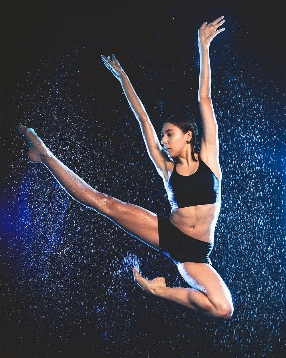 Female dancer mid-jump in the rain, photo by Brian Balloon Media