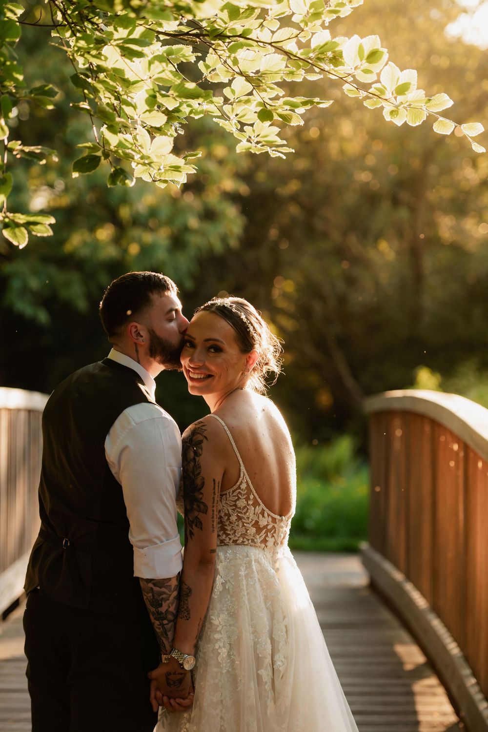 Romantic sunset moment on a wooden bridge surrounded by golden-lit foliage.