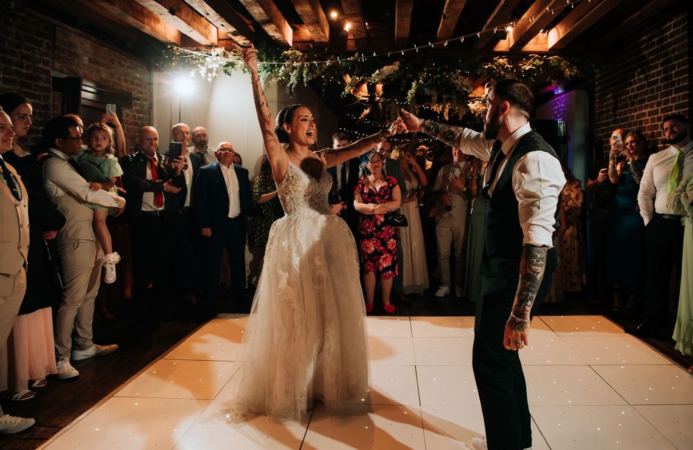 Wedding guests line the dance floor during a reception celebration.