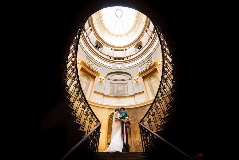 Looking up at an ornate circular domed ceiling with architectural details.