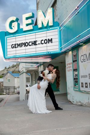 A series of wedding photos taken under a vintage theater marquee with GEM signage.