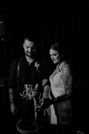A series of black and white romantic photos showing a couple embracing in dim lighting.
