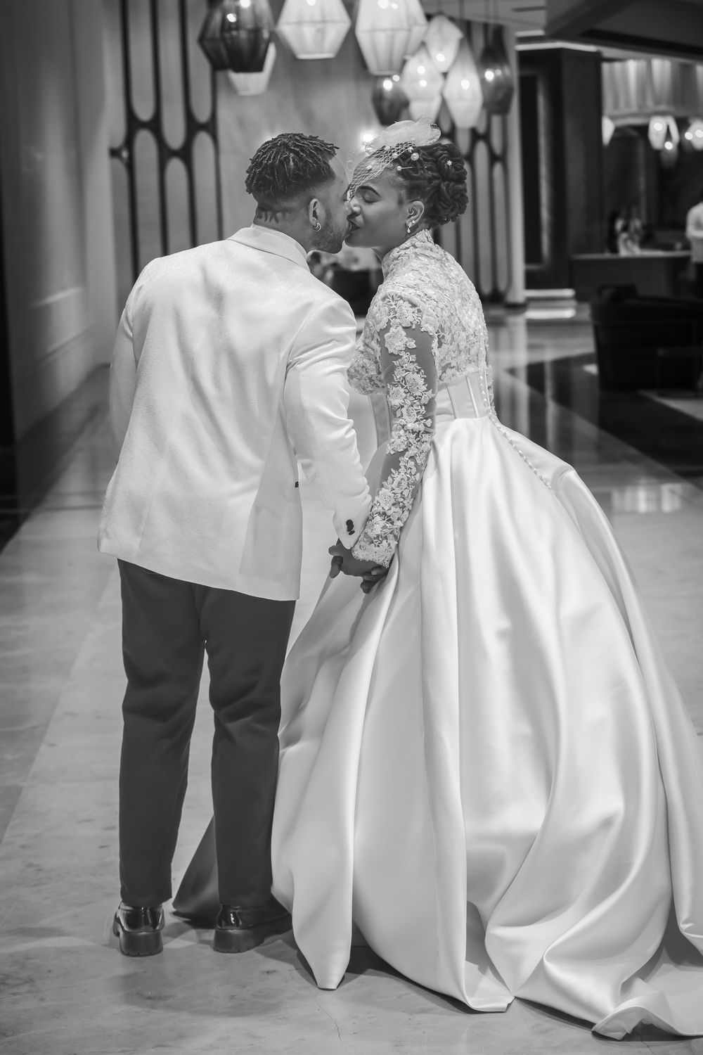 Bride and groom walking together at an elegant wedding reception.