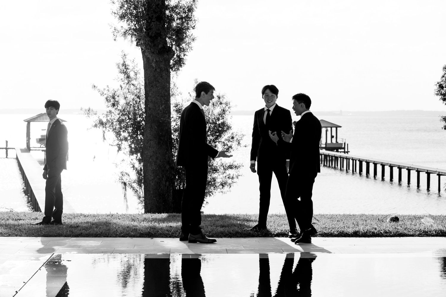 A set of black and white images showing silhouettes of people along walkways, trees, and waterfront scenery.