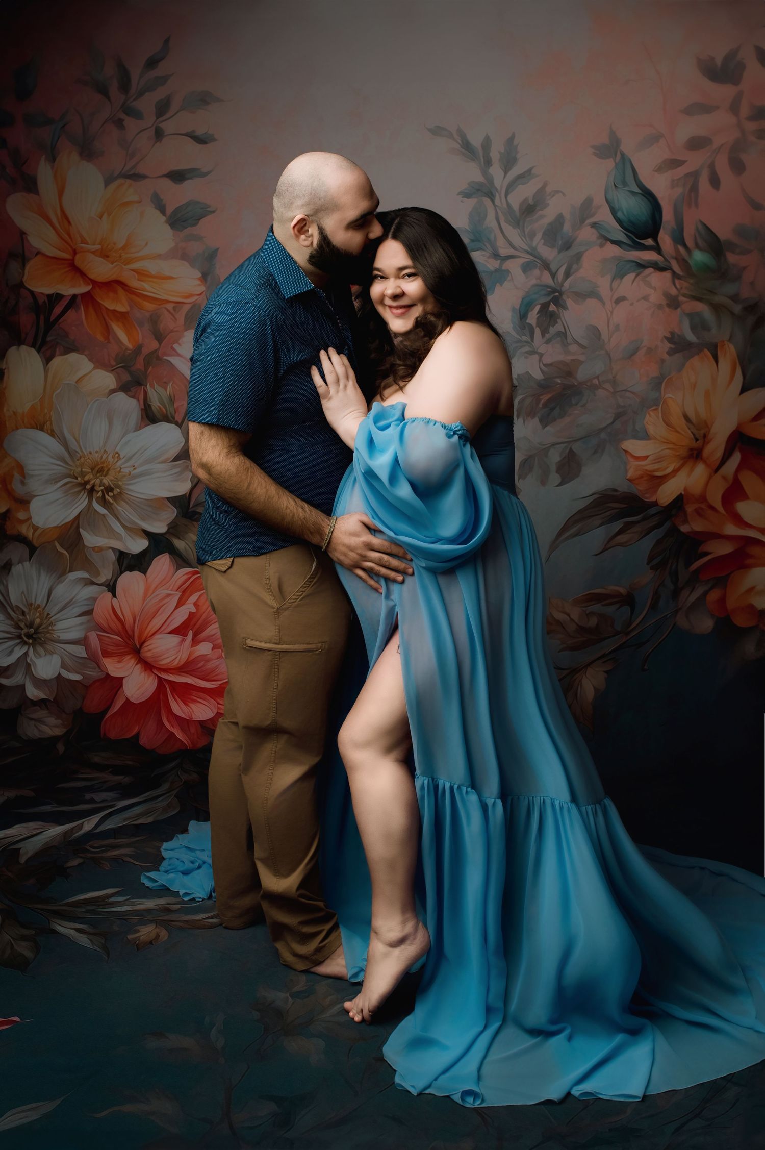 Artistic maternity photo with celestial elements and golden circular frame against black background.