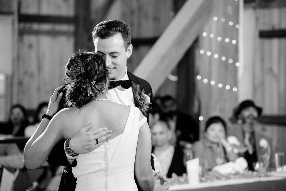 Bride and groom dancing on their wedding day at Peacock Ridge in North Lawrence, Ohio in a black and white photo showing them from the back