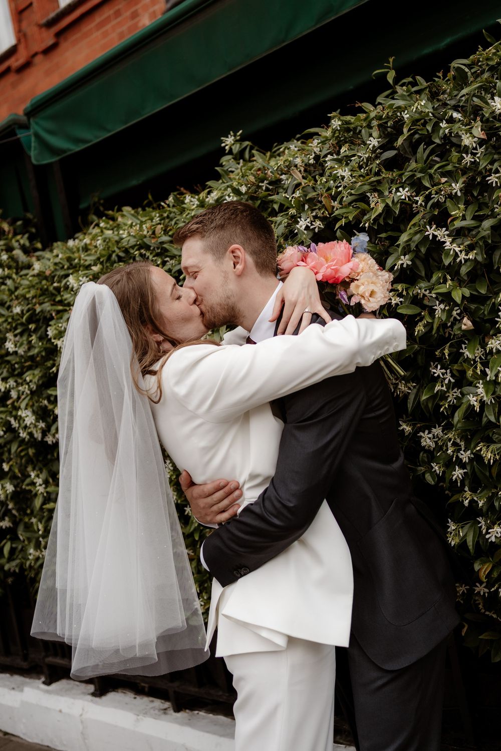 A romantic wedding sequence shows a couple embracing and sharing intimate moments against a backdrop of green foliage.