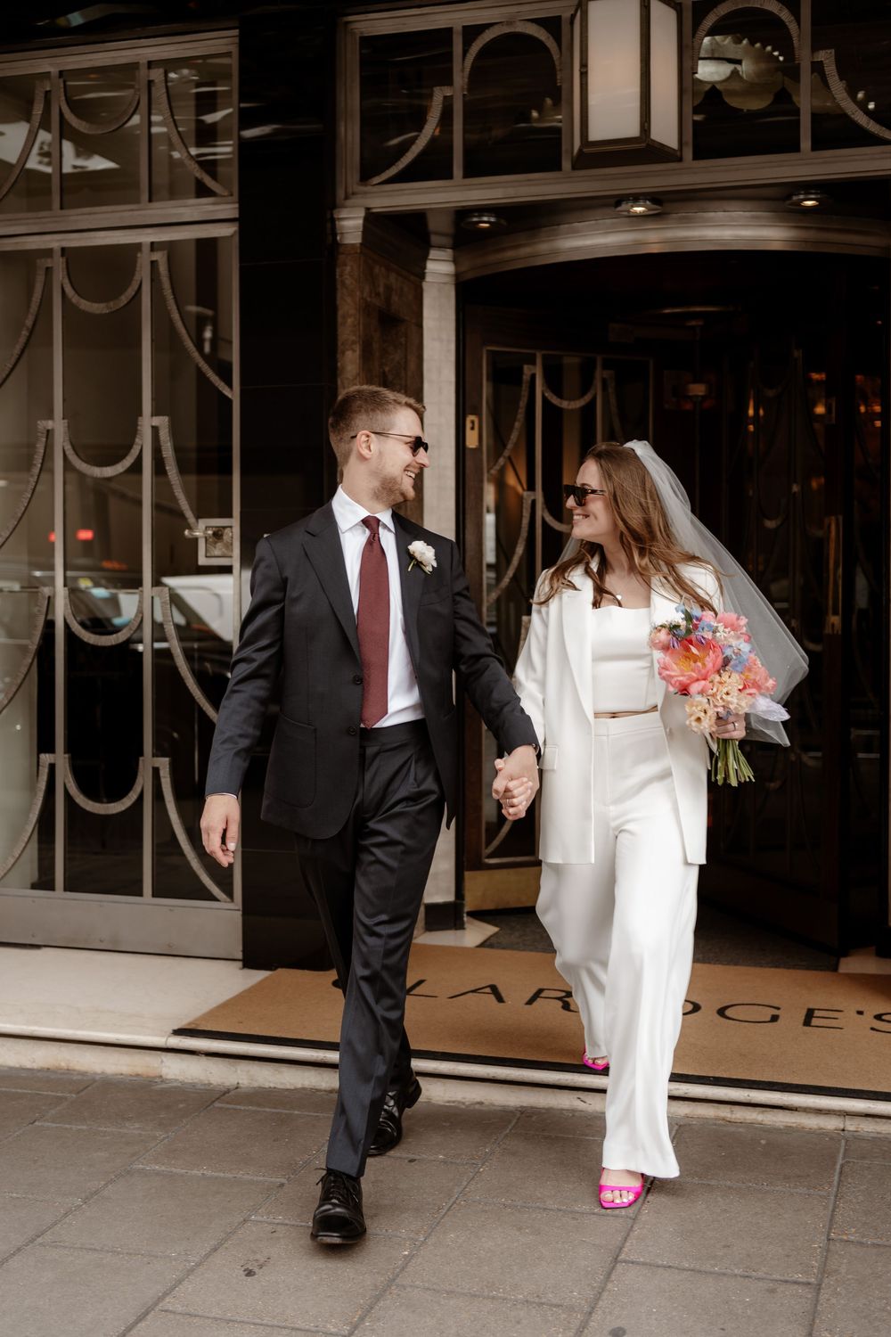 A couple in formal attire, with a white dress and dark suit, walking together on a sidewalk in a sequence of photos.