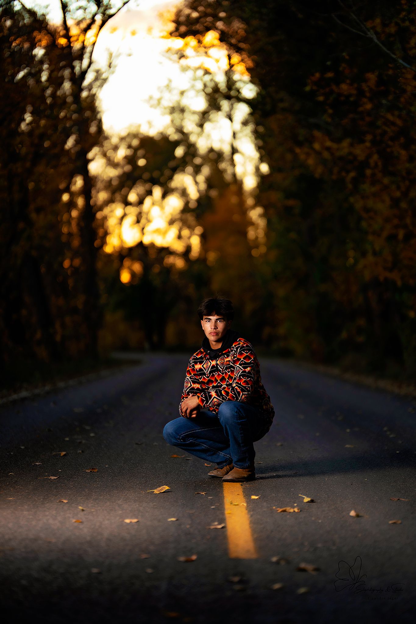 Dramatic portrait session on empty road during fall sunset in Williston, North Dakota.