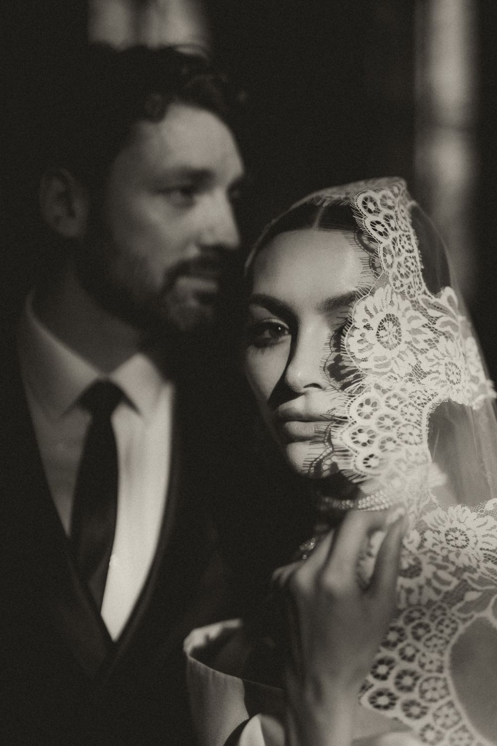 Artistic black and white wedding portraits featuring delicate lace details and romantic close-up compositions.