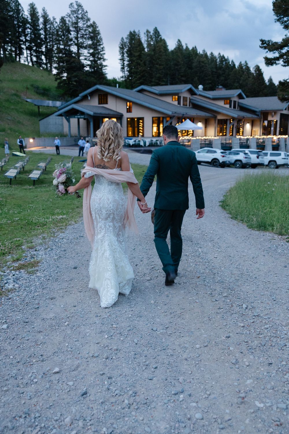 Bride and Groom walking back into the deer park chalet. Exterior view of the Deer Park Chalet