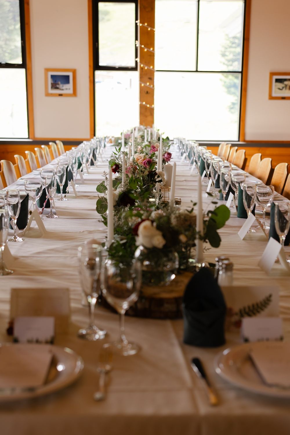 Family-style wedding seating, featuring banquet-style tables for intimate guest socialization at Bridger Bowl Ski Area