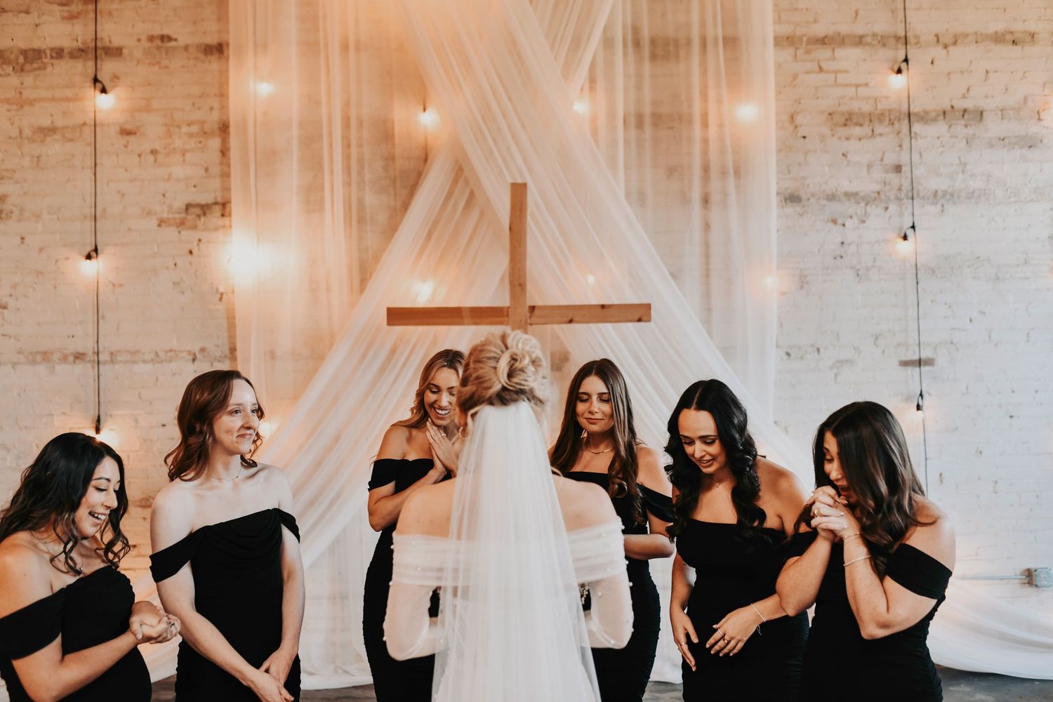 Bride sharing a joyful first look with her bridal party
