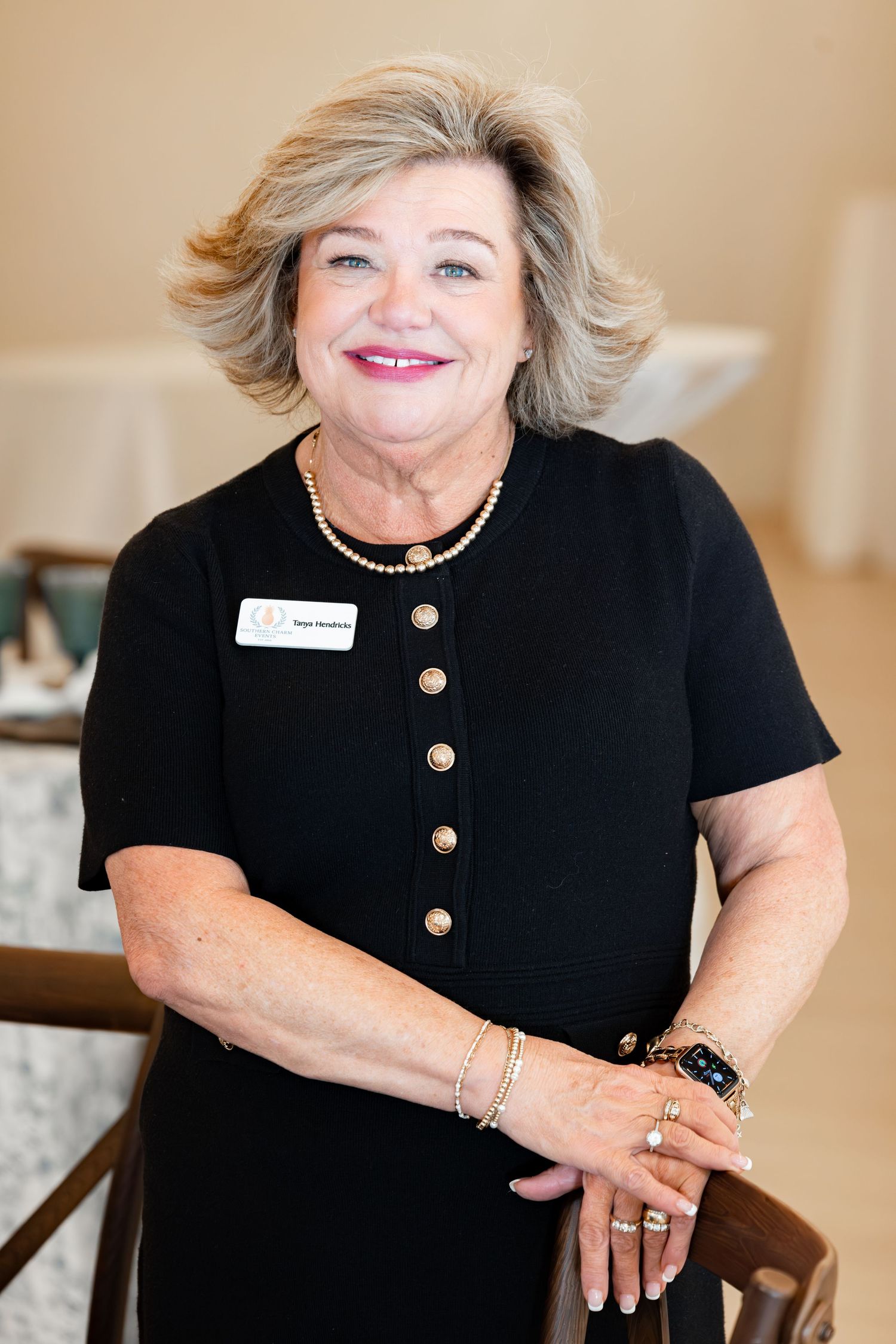 Professional headshots of woman wearing a black top with gold buttons in various poses against a neutral background.