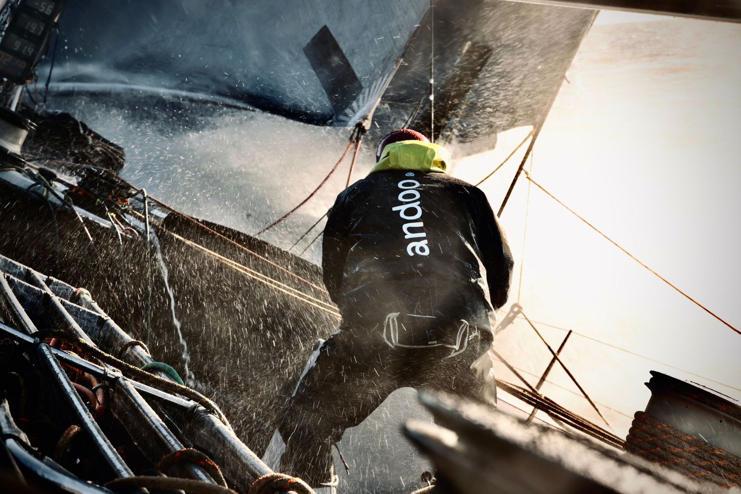 Police officer in tactical gear climbing up a wall during a training or emergency response operation.