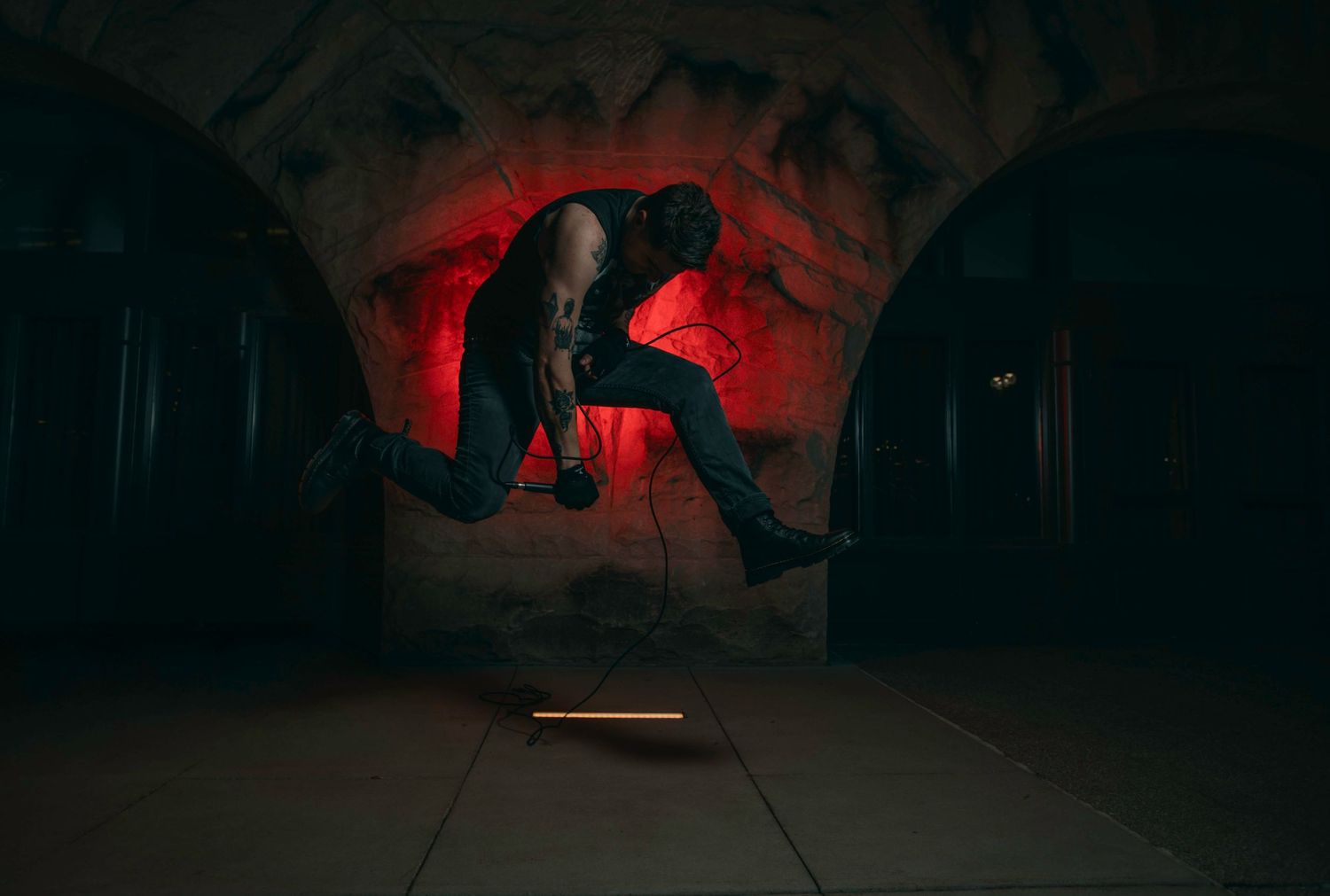 Dark cave interior lit with dramatic red lighting effects.