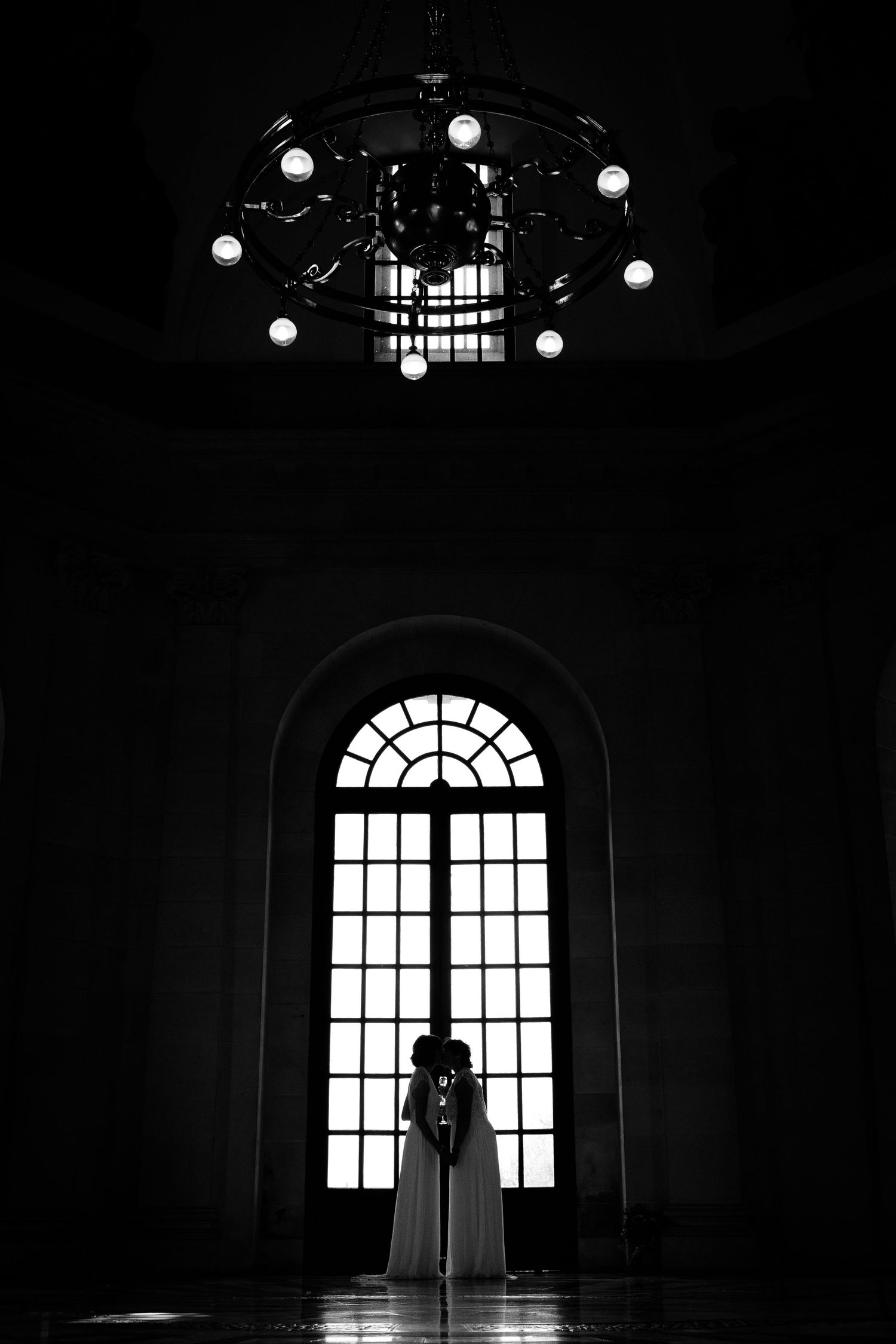 A dramatic black and white series showing a silhouette against a bright arched window in a dark interior space.
