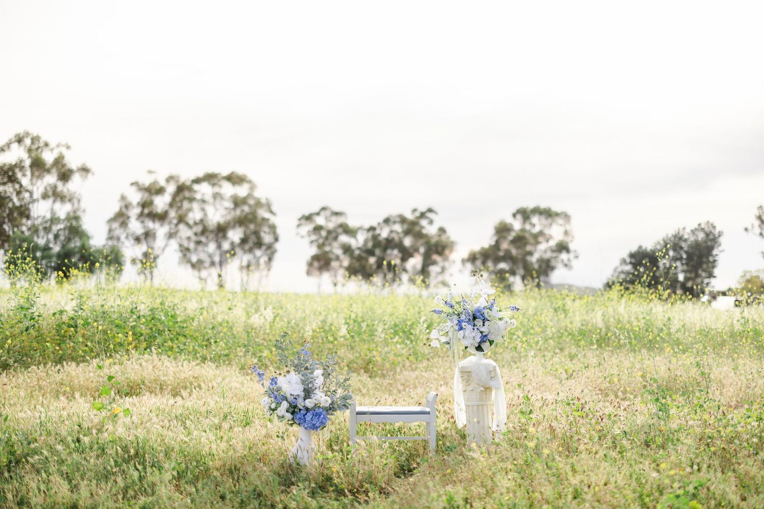 Panoramic view of a meadow with decorative elements and floral arrangements scattered throughout.