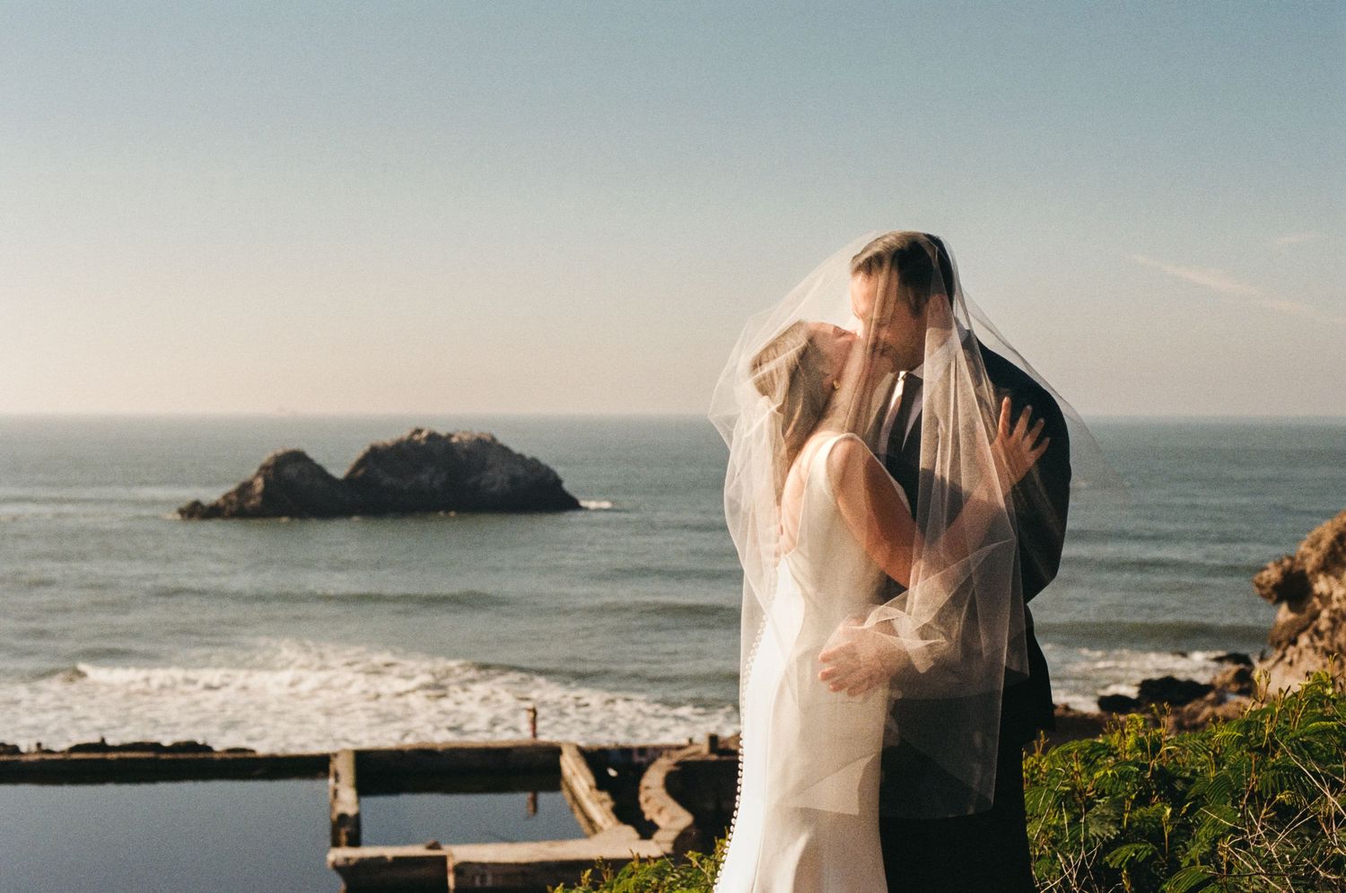 Scenic coastal wedding photography collage featuring ocean views, cliffside moments, and romantic beach scenes at sunset.