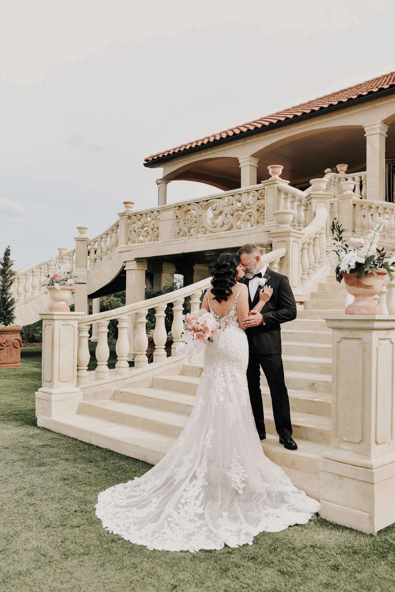 Bride and groom silhouetted at sunset in vineyard rows