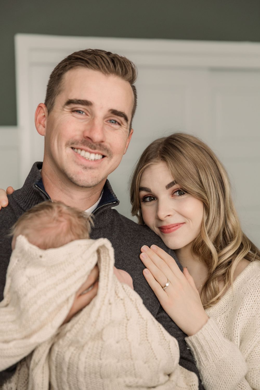 A couple in cozy cream and gray sweaters share intimate moments in a series of romantic portrait photos.