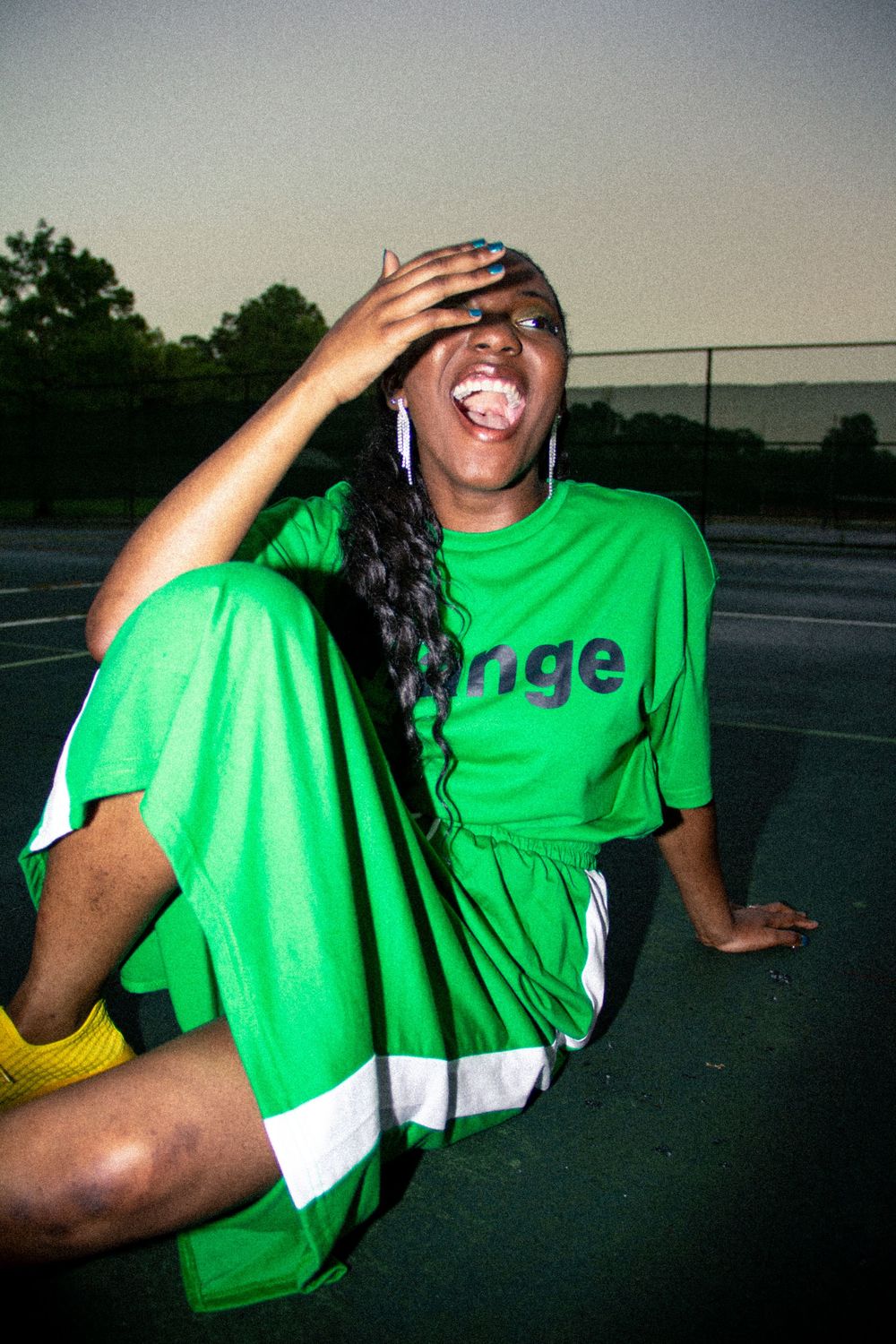 A person in a bright green t-shirt laughs joyfully in a series of candid outdoor photos.