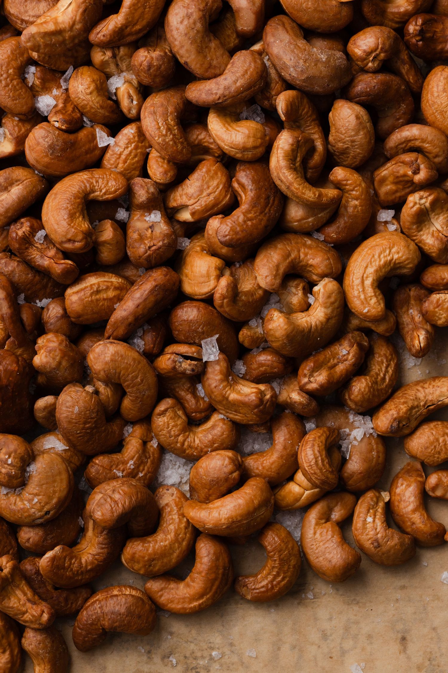 dark roasted cashews with flakey sea salt, macro with dramatic lighting