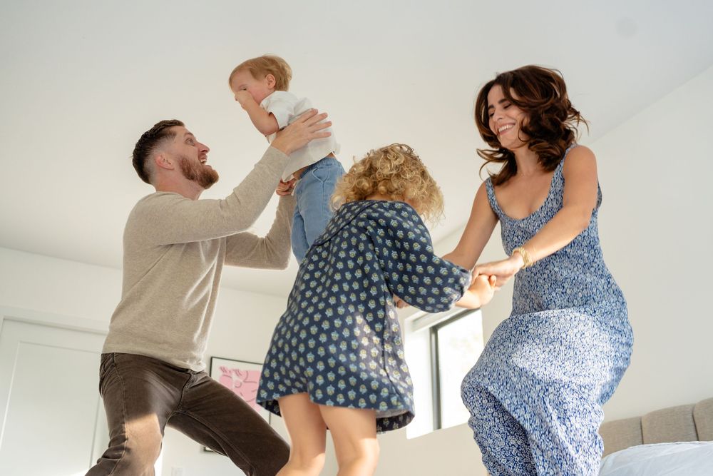 Joyful family moment captured in a series of candid photos showing playful interaction on a bed.