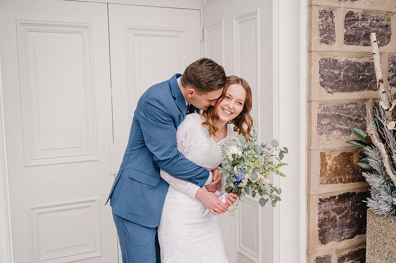 A series of wedding photos showing a couple embracing in front of a white paneled wall with stone accents.