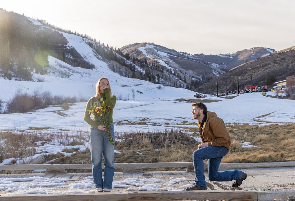A sequence of proposal photos in a snowy mountain landscape shows a couple during a romantic moment.