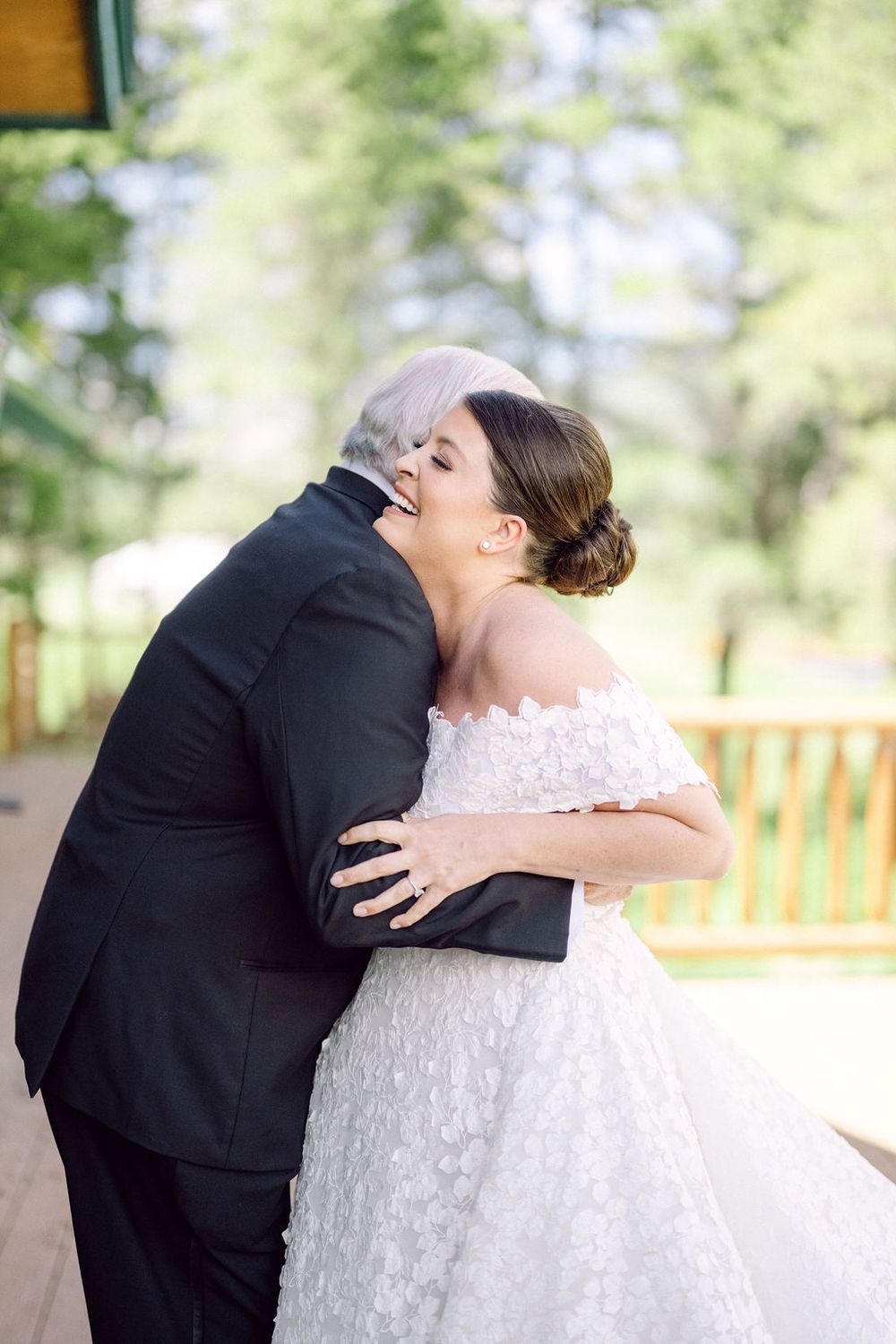 A sequence of four wedding photos showing a couple in formal attire embracing while sitting on a wooden bench outdoors.