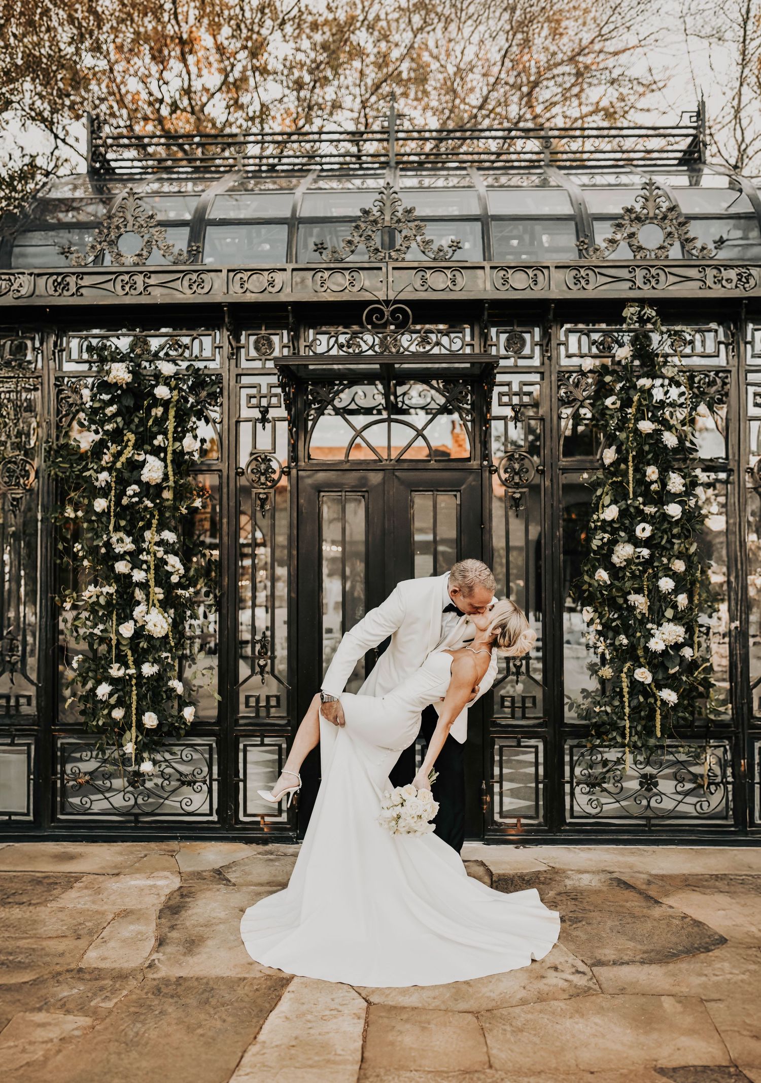 Romantic wedding photo of a groom dipping his bride