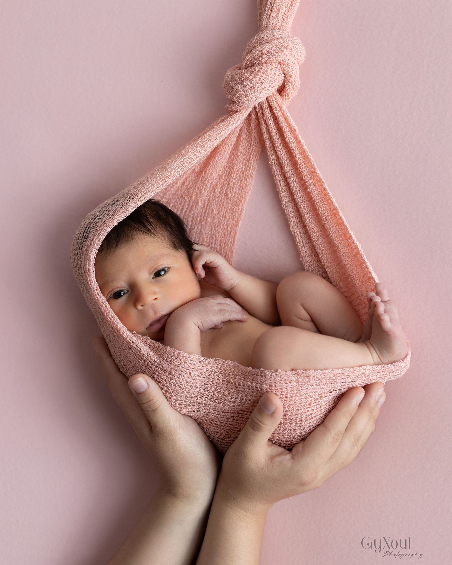 Newborn photography sequence showing baby wrapped in soft pink blanket held in hands against pink backdrop.