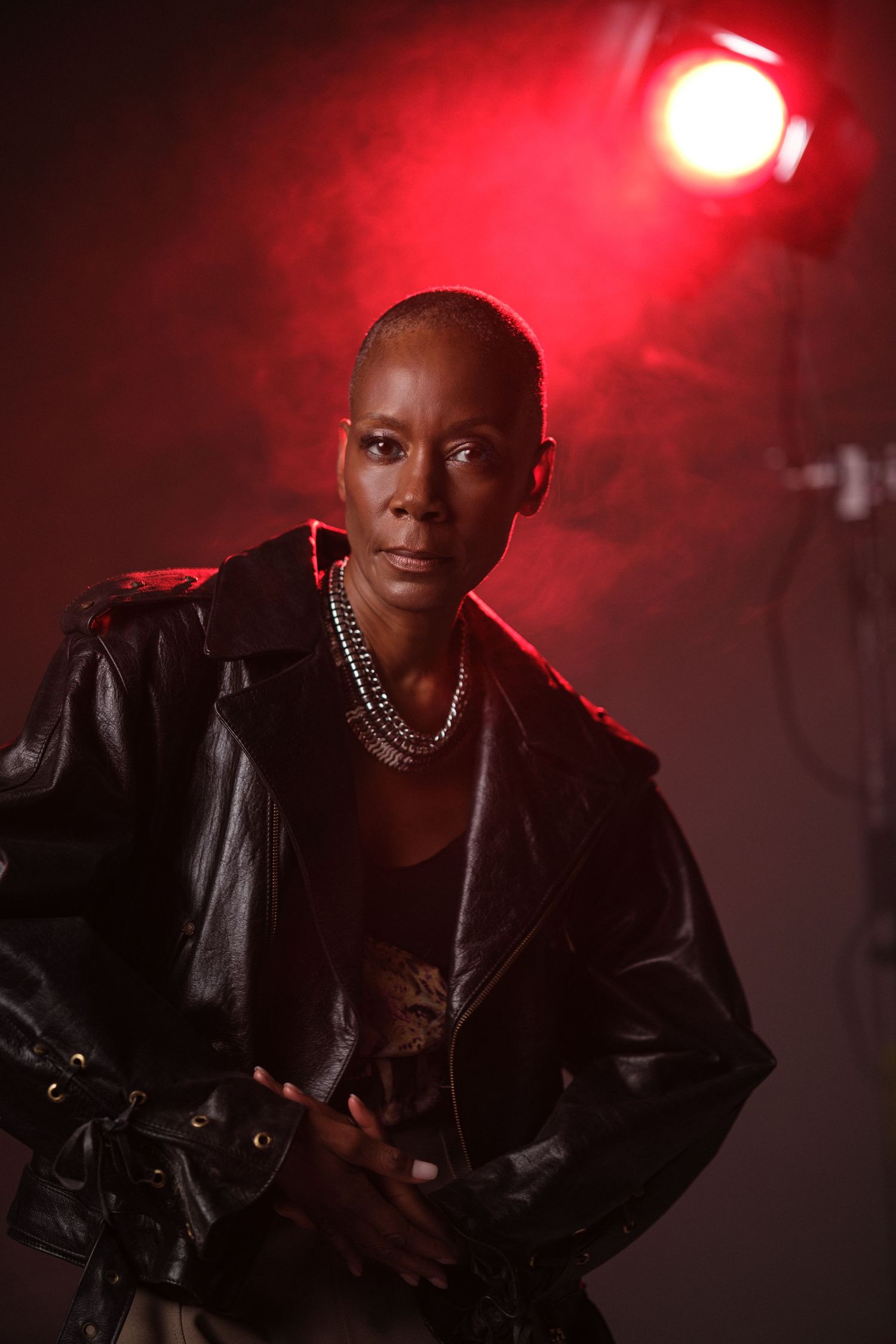 Atmospheric portrait series with red lighting effects and leather jacket styling.