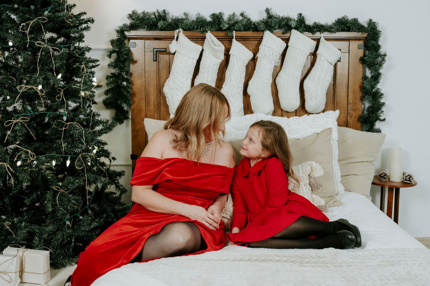 Series of six lifestyle photos showing a white bed with pillows and red accents against a Christmas tree background.