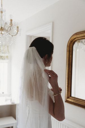 Bride adjusting veil at Henham Park Wedding