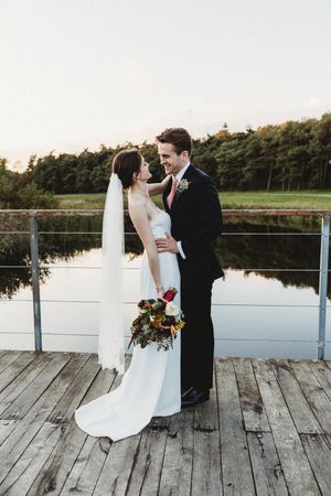 Bride and Groom face to face on Latitude bridge at Henham Park