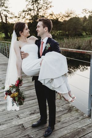 Groom Carrying Bride on Iconic Latitude Bridge at Henham Park wedding