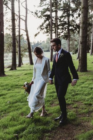 Bride and Groom take a walk in the woodlands at Henham Barns