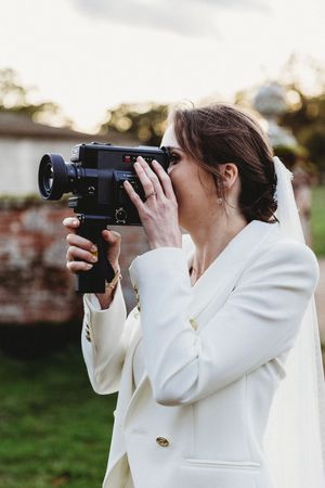 Candid shot of bride using super 8 camera at Henham Barns