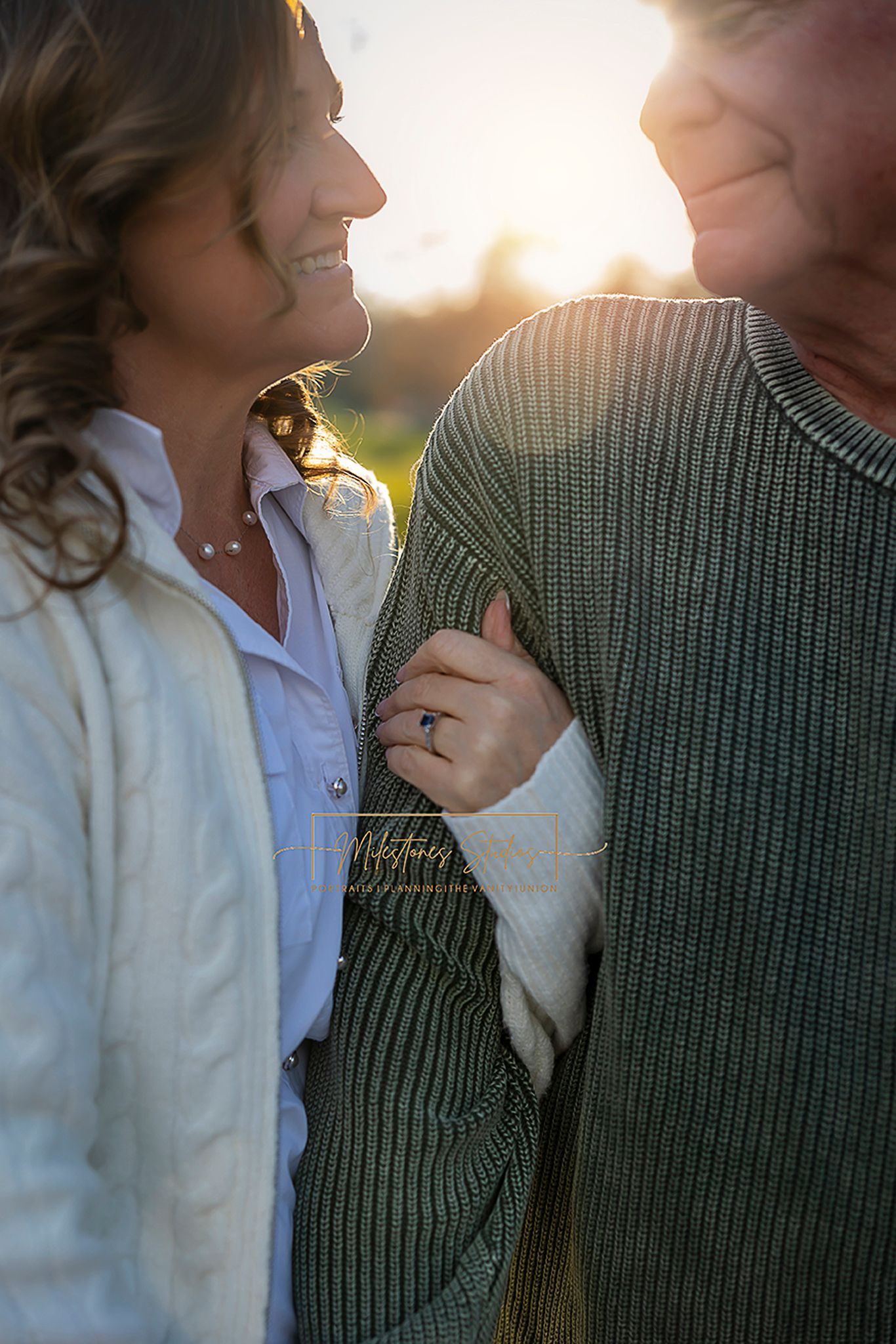 Engagement photo of couple with focus on her ring. Boise greenbelt engagement photos
