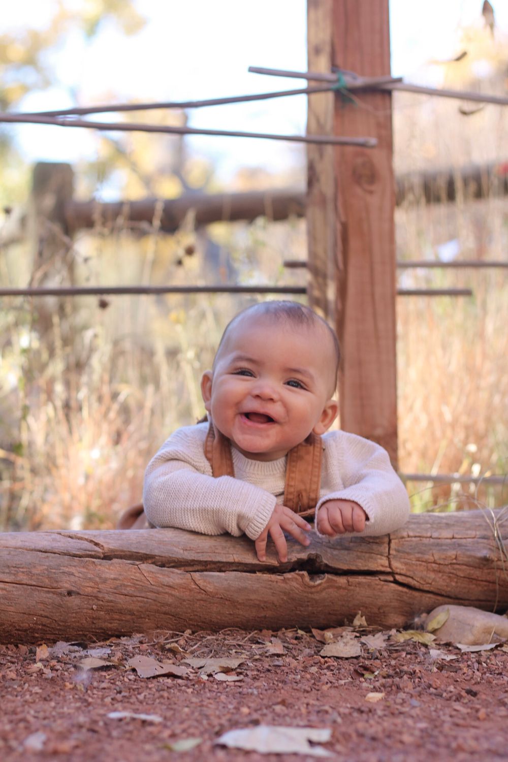 Baby lying outdoors during a relaxed family photography session in Albuquerque