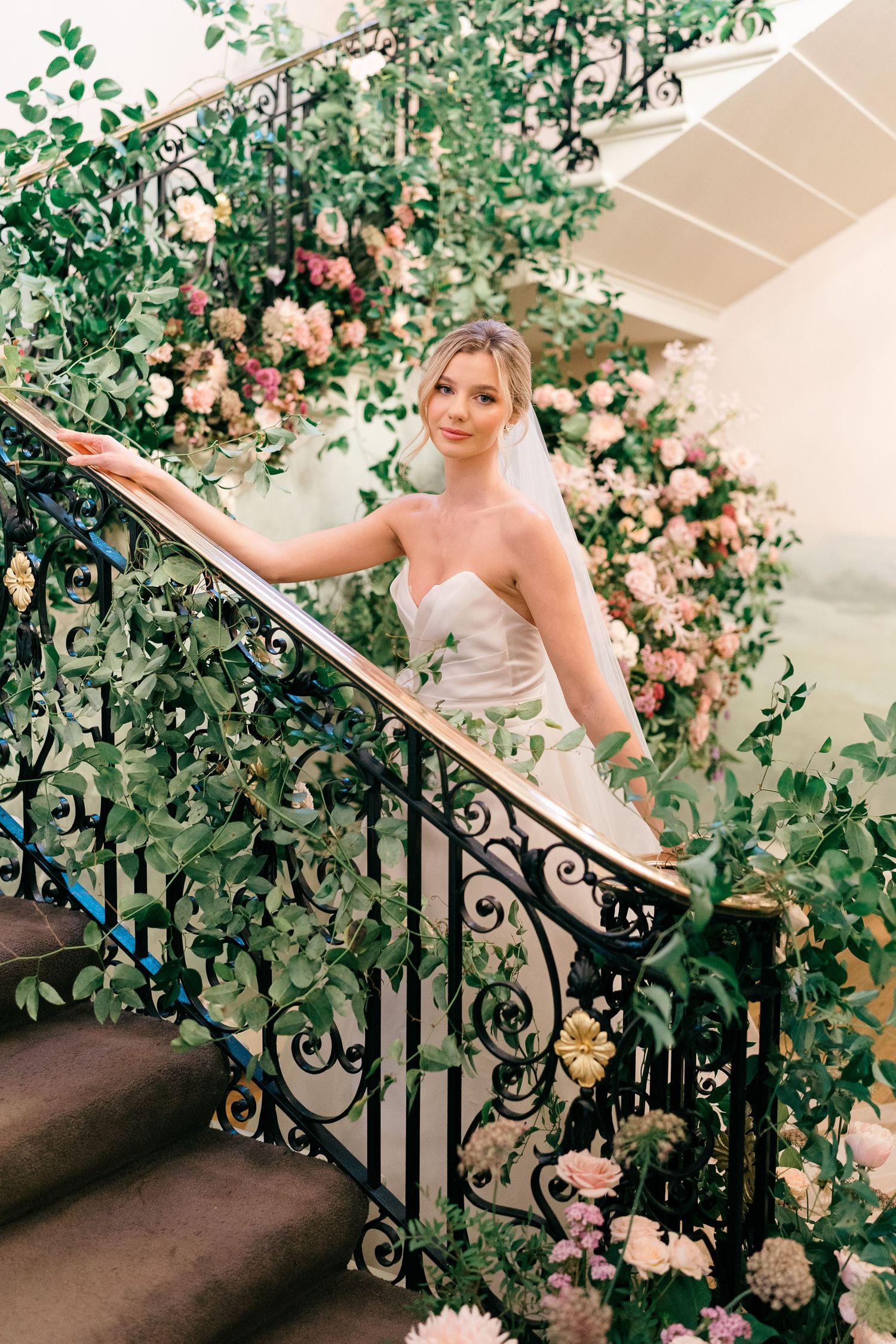 A series of vintage-style photos showing someone posing on a staircase adorned with climbing roses and ornate railings.