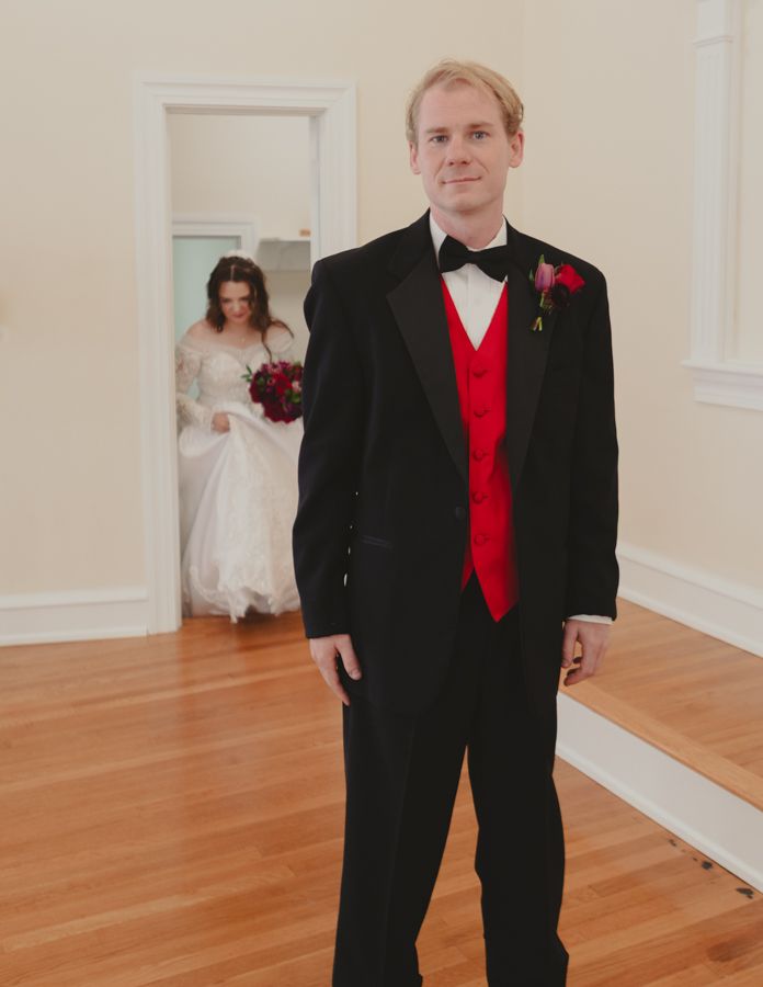 husband waiting for wife for the first look. Wife in background coming in for her entrance.
